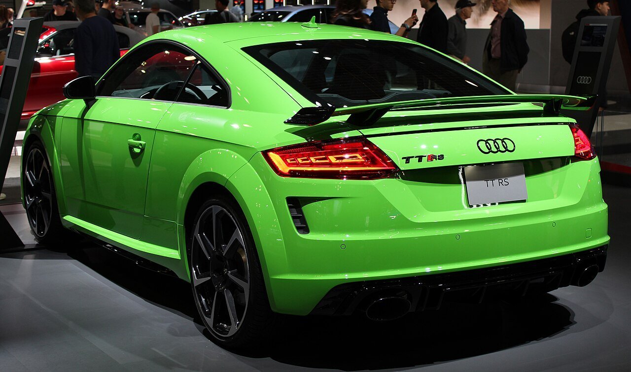The same green 2019 Audi TT RS 8S coupe viewed from the rear-left at the New York auto show.