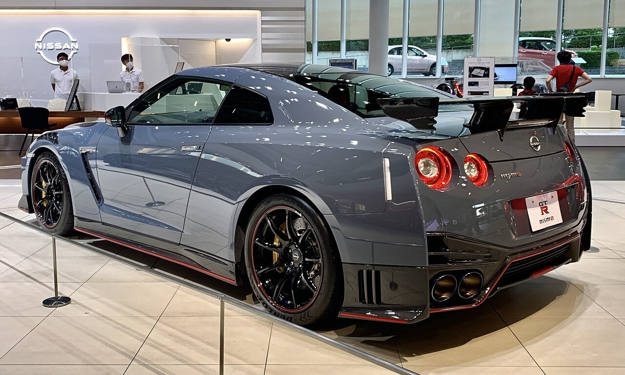 The same Nissan GT-R NISMO Special Edition display coupe viewed from the rear-left, showing its wing and red wheel accents.