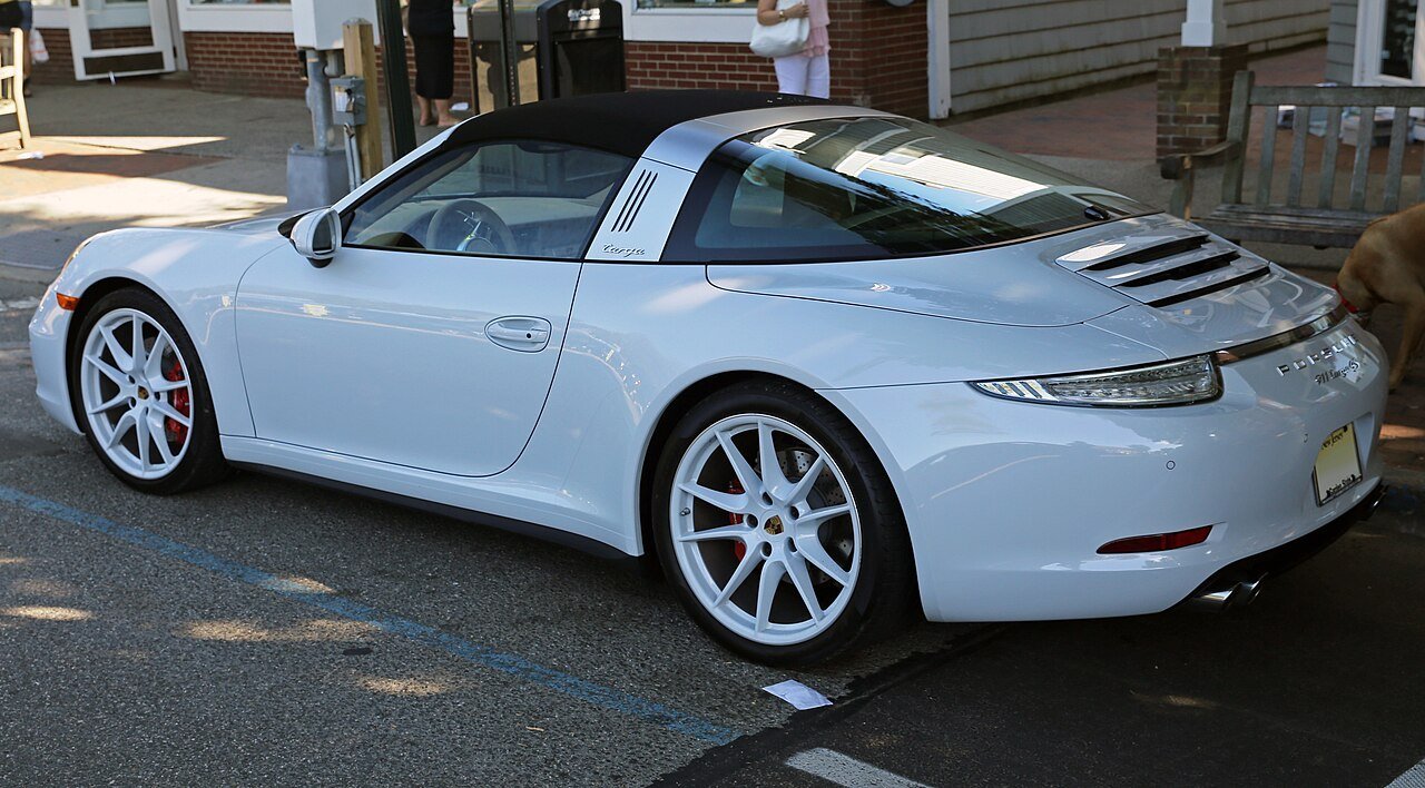The same white 2015 Porsche 911 Targa 4S 991.1 viewed from the rear-left, showing the roof bar and curved rear glass.