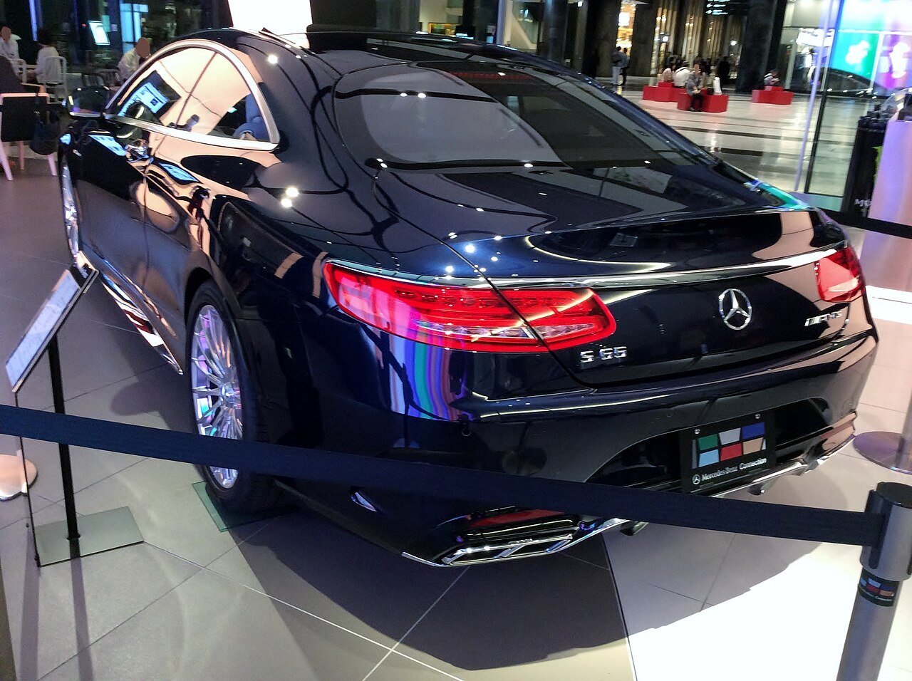 Matching blue Mercedes-Benz S65 AMG C217 coupe viewed from the rear-left, showing its S65 badge.